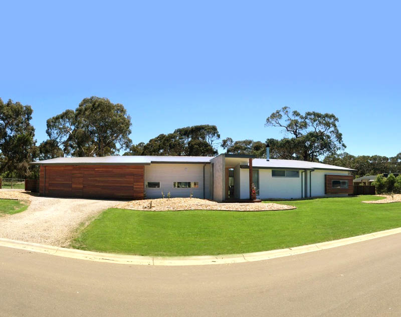 Single-level home with broad rooflines and warm timber cladding