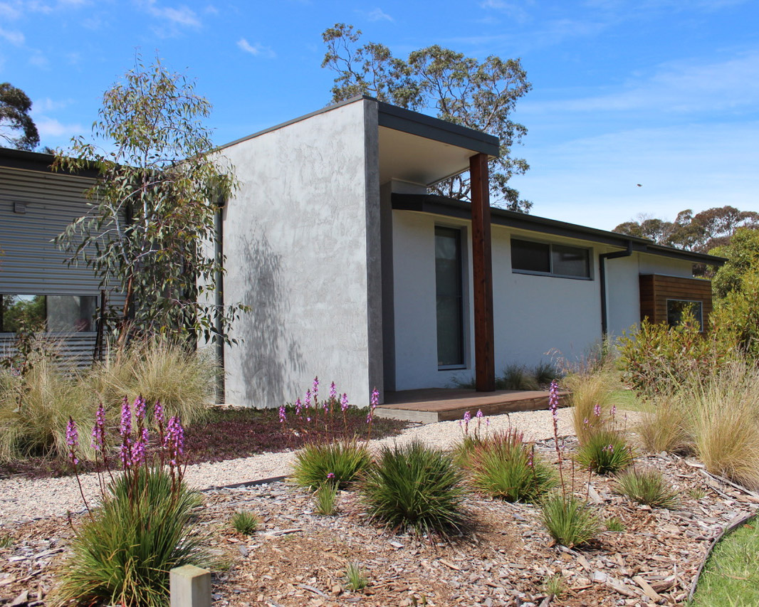 Contemporary custom home surrounded by native landscaping