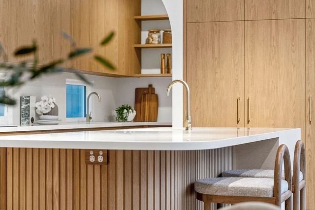 Custom kitchen joinery with timber cabinetry and stone benchtops